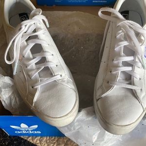 Flashy white tennis shoes